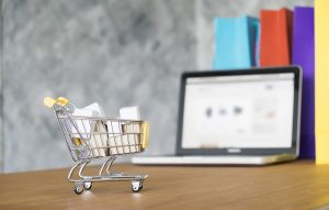 Business theme internet online shopping concept shopping delivery shopping cart carry shopping mail box and blur background of shopping bag and open laptop